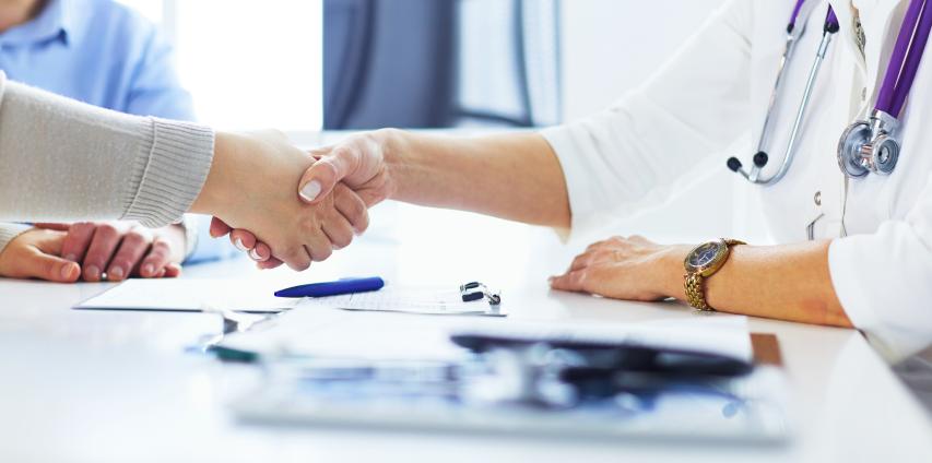Woman Doctor Handshaking With A Professional